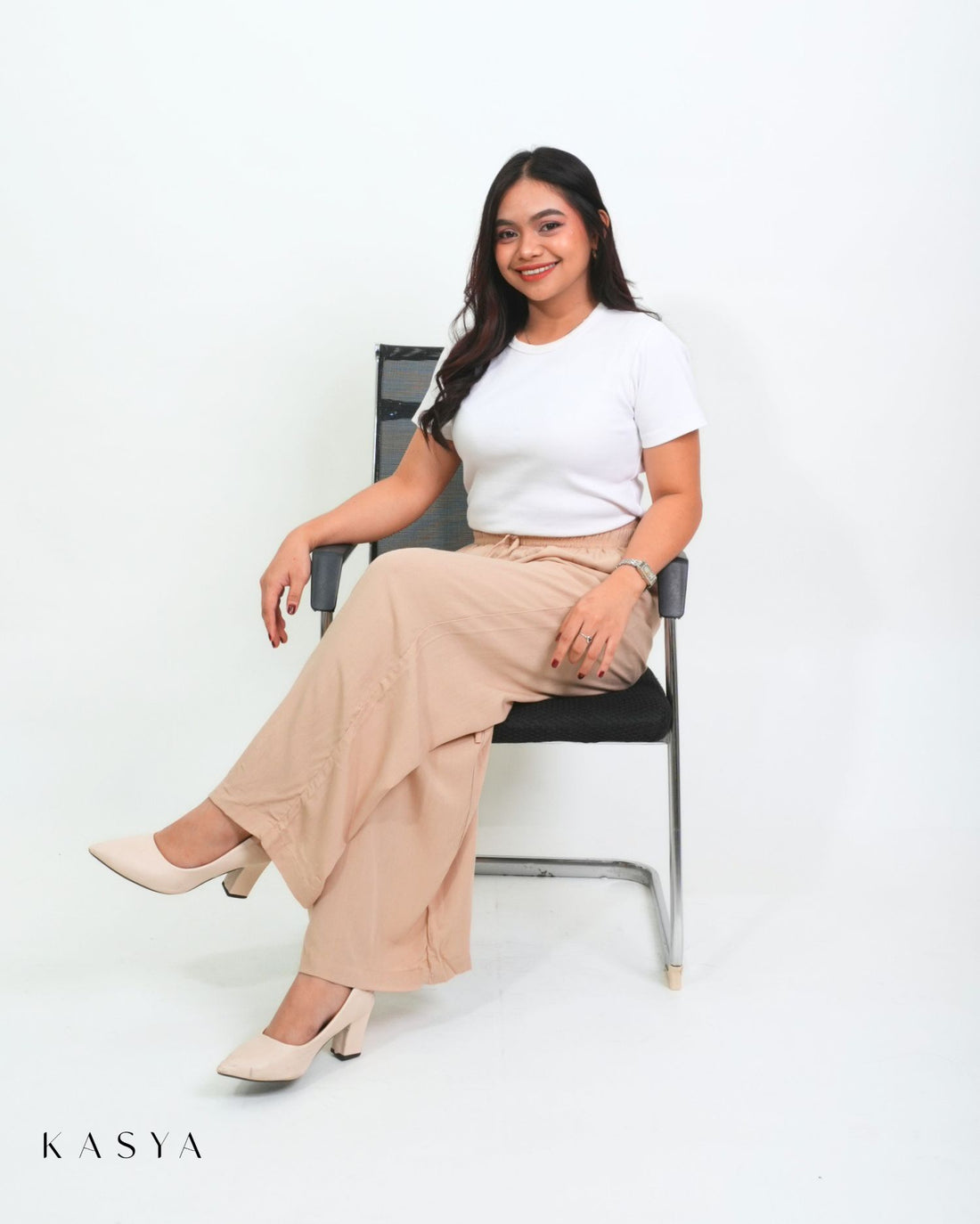 Beige wide-leg pants, sitting view